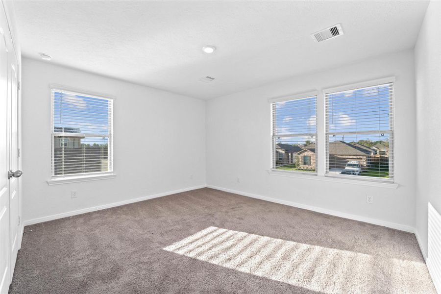 This secondary bedroom will not disappoint with the large windows and natural lighting. It also offers plush carpeting, neutral paint tones, recessed lighting, and a generously sized closet. This secondary bedroom will not disappoint with the large windows and natural lighting. It also offers plush carpeting, neutral paint tones, recessed lighting, and a generously sized closet.