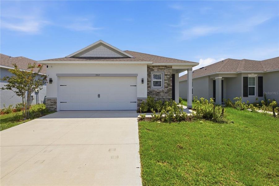 Front exterior of a new home in , Harmony, FL, highlighting curb appeal (Image 25). Front exterior of a new home in , Harmony, FL, highlighting curb appeal (Image 25).