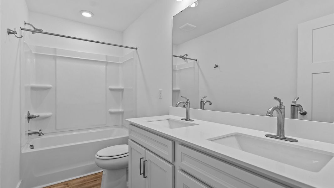 Highly skilled design seen in this polished and practical full bathroom