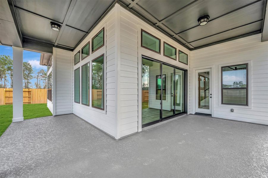 Exterior details and patio area of a home in ARTAVIA 50' Homesites, Conroe (Image 26).