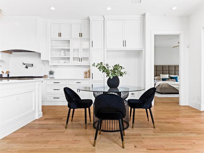 Dining space with light hardwood / wood-style flooring