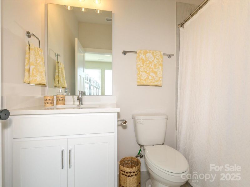 Single bowl vanity and tub-shower combination.  Tile flooring.