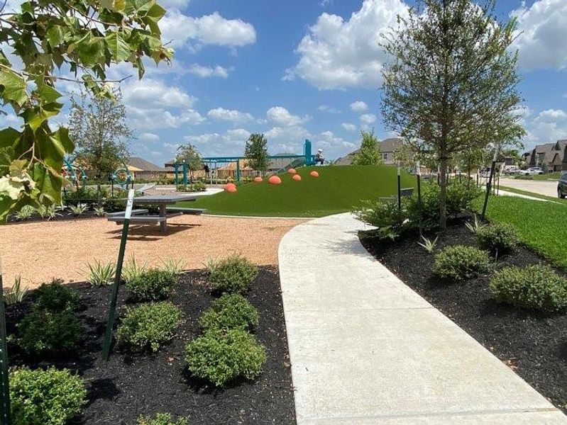 Neighborhood park, where joy and laughter echo through the air. A haven for kids to enjoy, this inviting space features playgrounds, green open fields, and benches for parents to relax while children explore and create lasting memories.