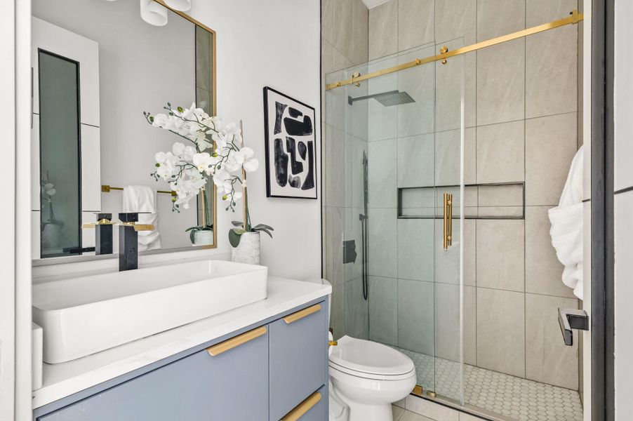 Modern bathroom with sleek fixtures and a spacious walk-in shower. Modern bathroom with sleek fixtures and a spacious walk-in shower.