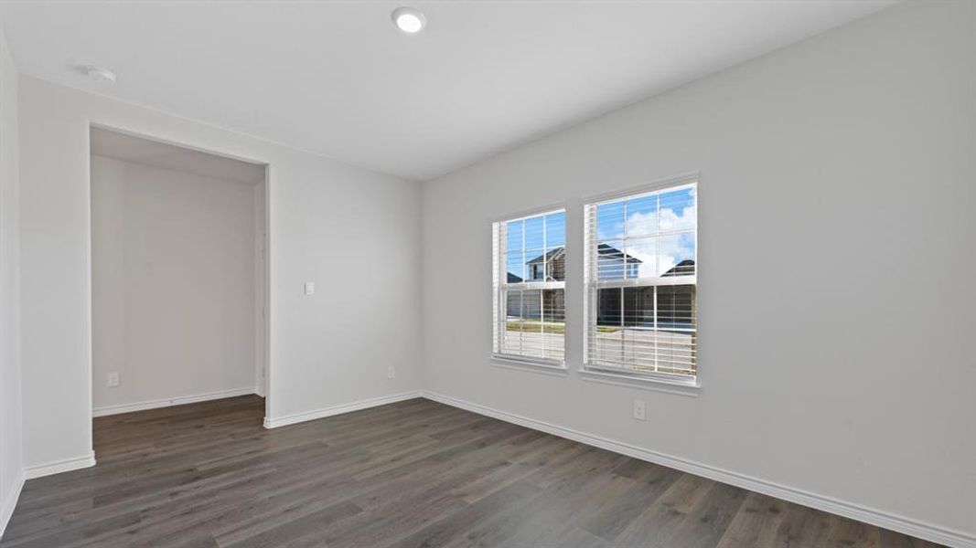 Unfurnished room with dark wood finished floors and baseboards Unfurnished room with dark wood finished floors and baseboards