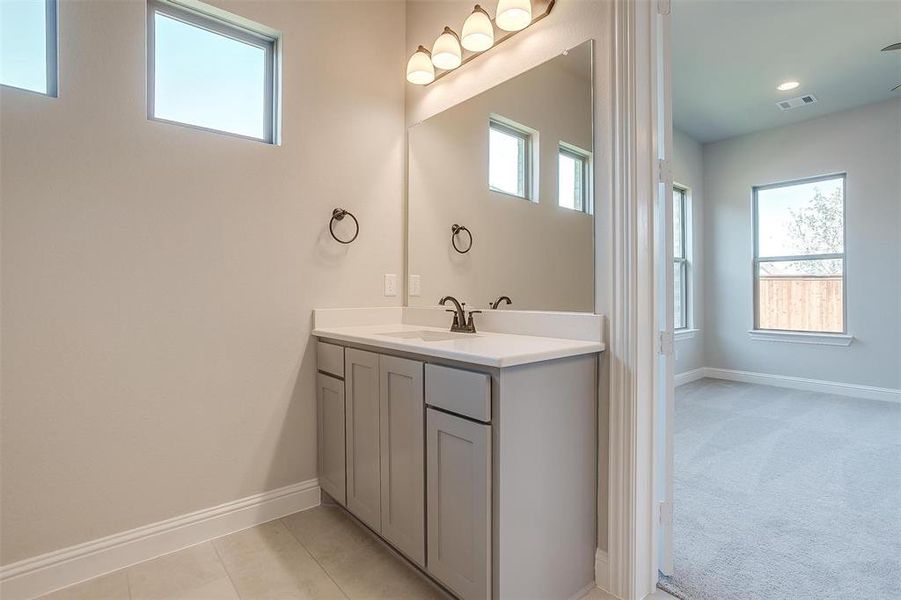 Bathroom with tile patterned floors and vanity