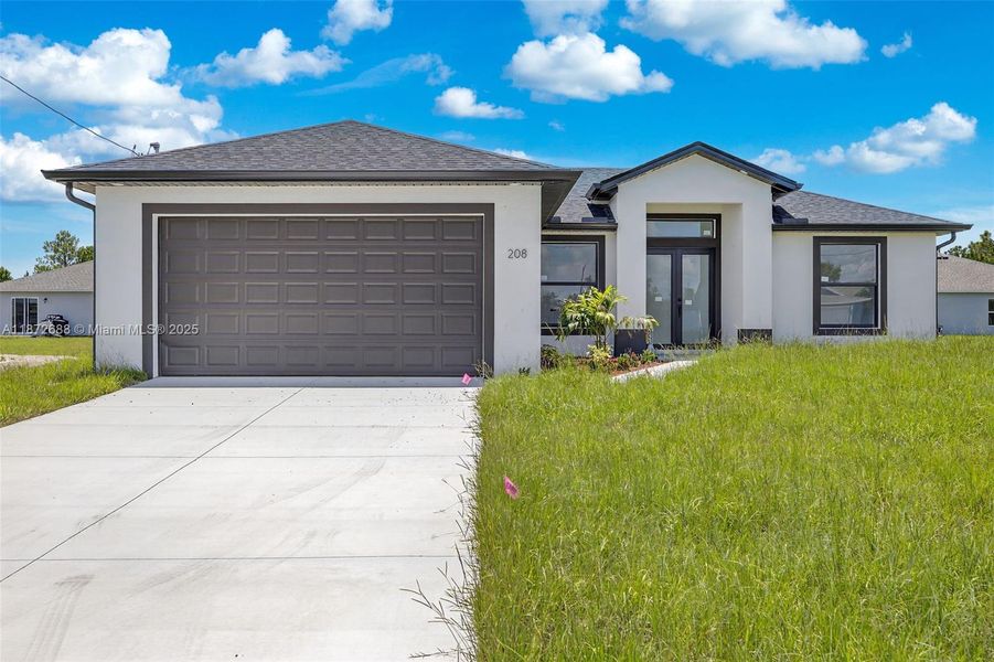 Front exterior of a new home in , Lehigh Acres, FL, highlighting curb appeal (Image 1).