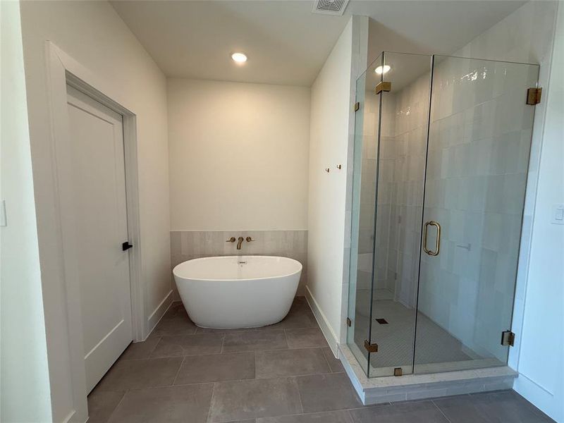 Bathroom featuring shower with separate bathtub and tile patterned floors