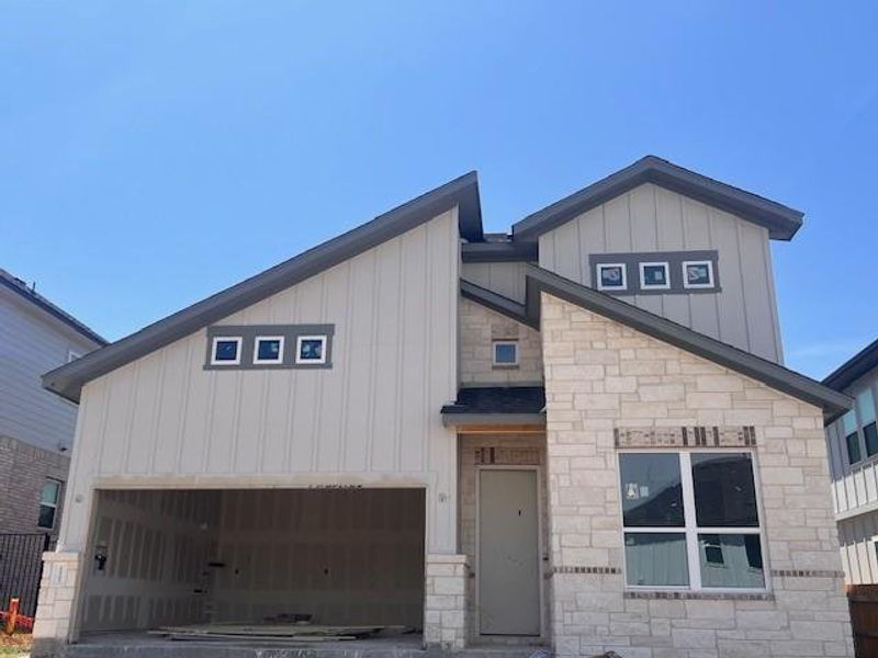 Front exterior of a new home in Cascades at Onion Creek, Austin, TX, highlighting curb appeal (Image 1).