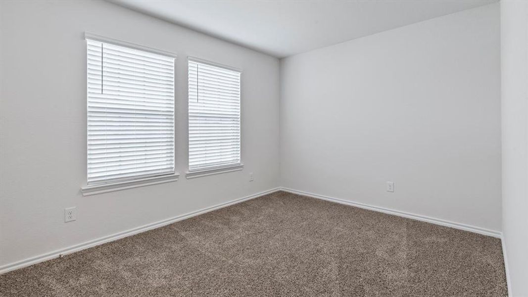 Unfurnished room with dark carpet and baseboards