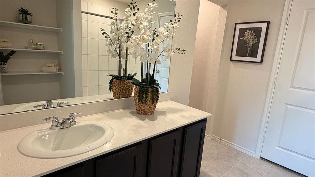 Bathroom with vanity and light tile patterned flooring