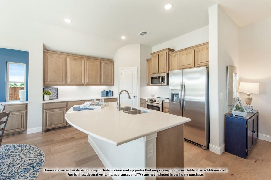 Kitchen with center island, sink, light wood cabinets, and stainless steel appliances on hardwood floors Kitchen with center island, sink, light wood cabinets, and stainless steel appliances on hardwood floors