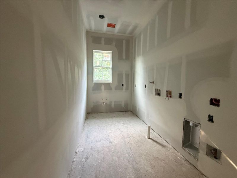 Utility room will feature built in clothes hamper (custom cabinetry) and include a sink.