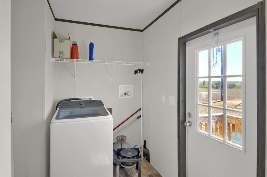 Laundry area with washer / dryer and ornamental molding