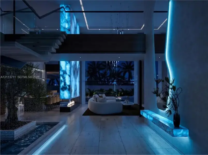 Open-concept interior featuring large-format stone flooring, back-lit stone column, linear fireplace, and integrated LED wall accent