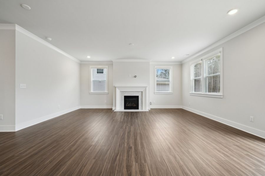 A large empty room with a fireplace. A large empty room with a fireplace.