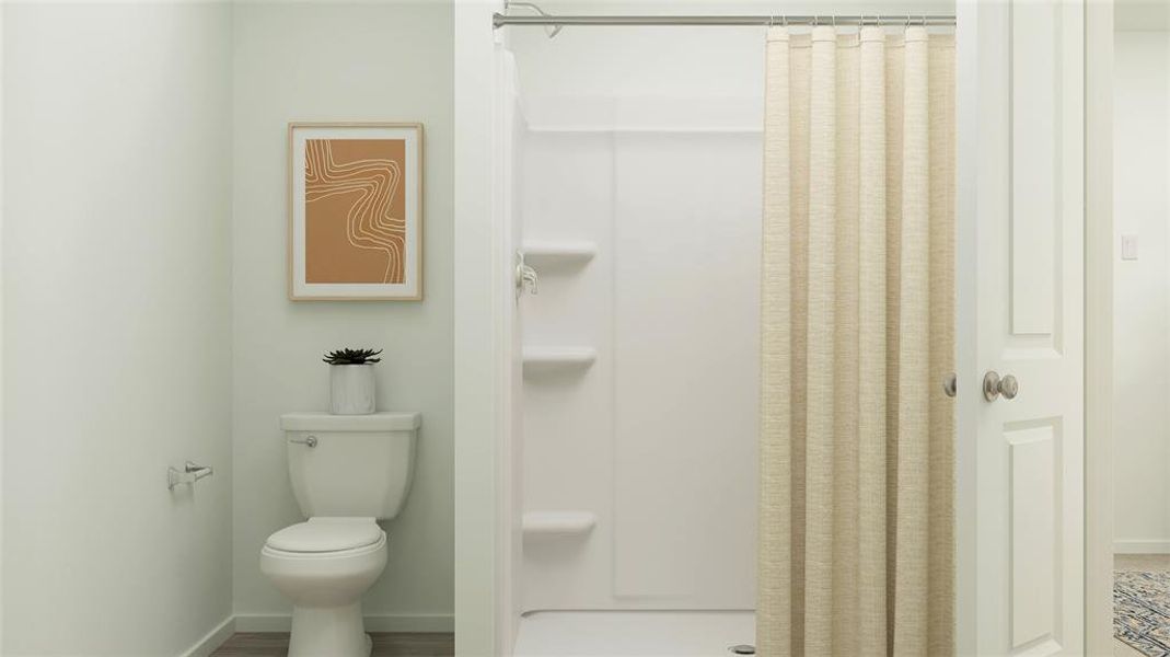 Bathroom featuring a stall shower and wood finished floors Bathroom featuring a stall shower and wood finished floors