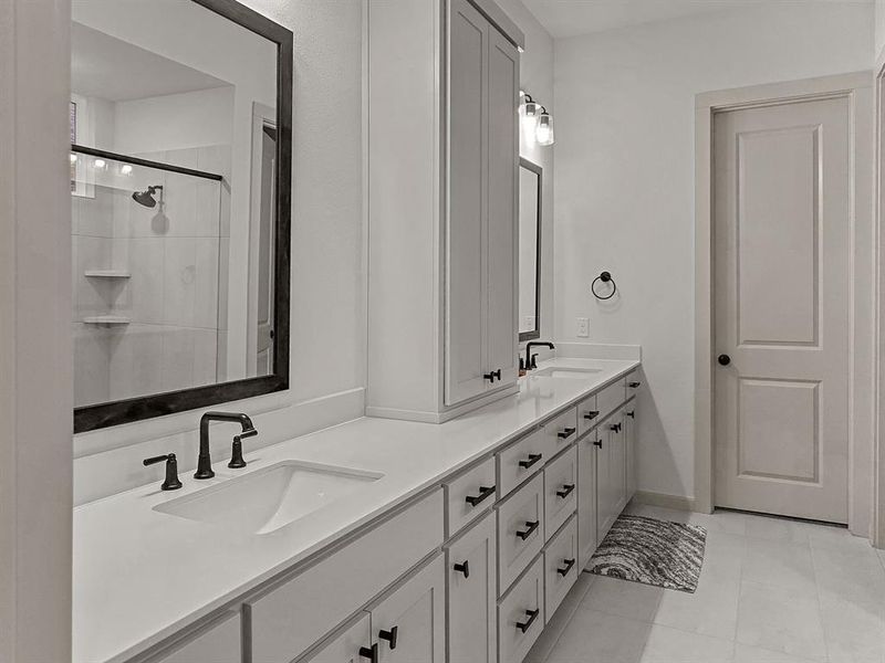 Master Bathroom with a shower with door, tile patterned floors, and vanity