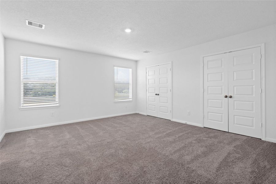 Head upstairs to the primary bedroom where you can relax and recharge! Enjoy the comfort of plush carpeting, neutral toned walls, high ceilings, recessed lighting, and windows that fill the room with natural light. Head upstairs to the primary bedroom where you can relax and recharge! Enjoy the comfort of plush carpeting, neutral toned walls, high ceilings, recessed lighting, and windows that fill the room with natural light.