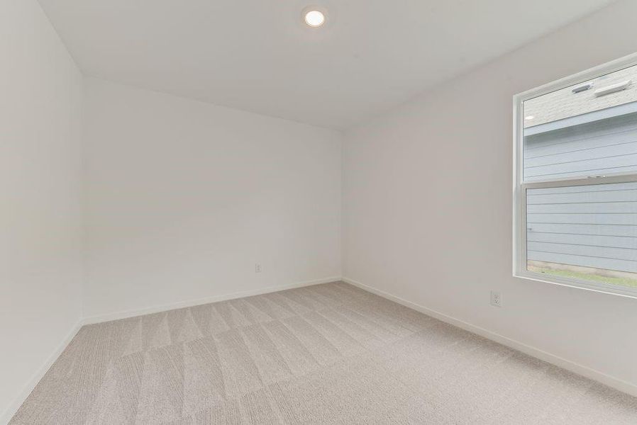 Empty room with recessed lighting, light colored carpet, and baseboards