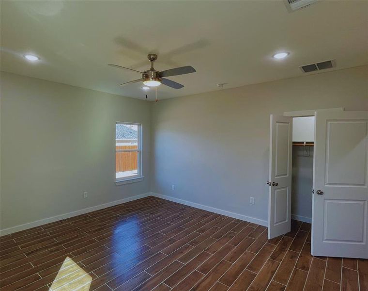 Empty room featuring dark hardwood / wood-style floors and ceiling fan