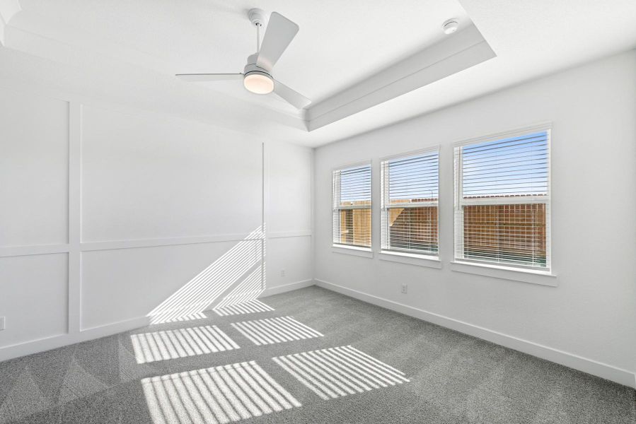 Spacious primary suite with feature wall