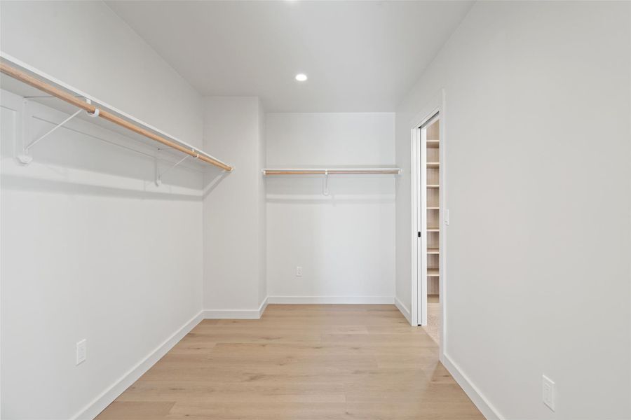 Walk in closet featuring wood finished floors