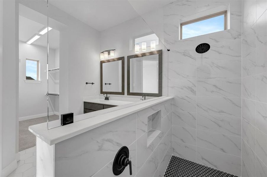 Bathroom with double vanity and a marble finish shower Bathroom with double vanity and a marble finish shower