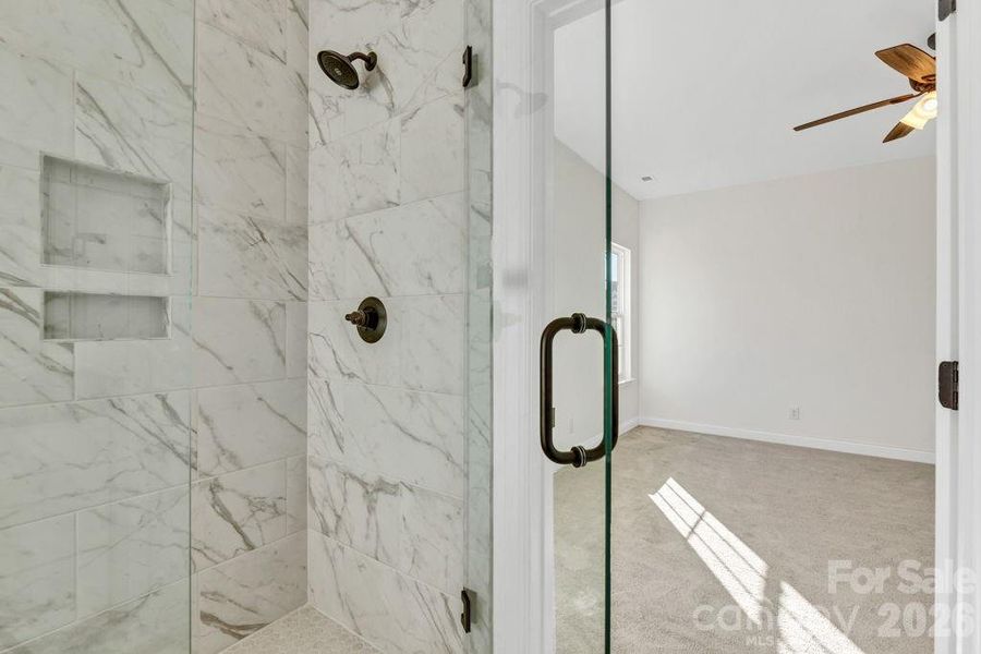 Tiled shower with frameless glass shower doors