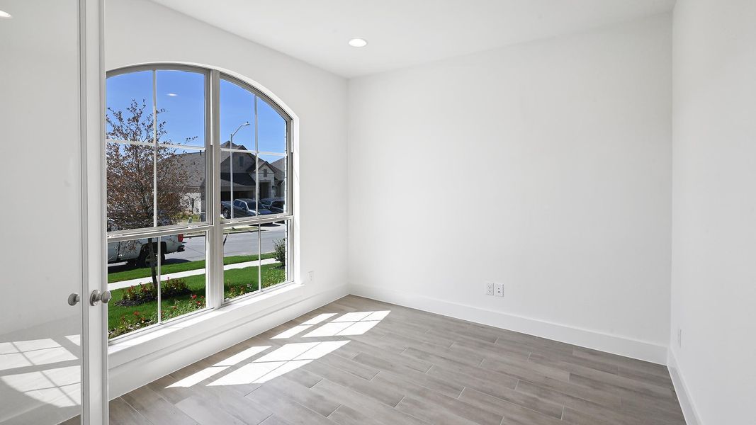 Empty room with wood finished floors and recessed lighting