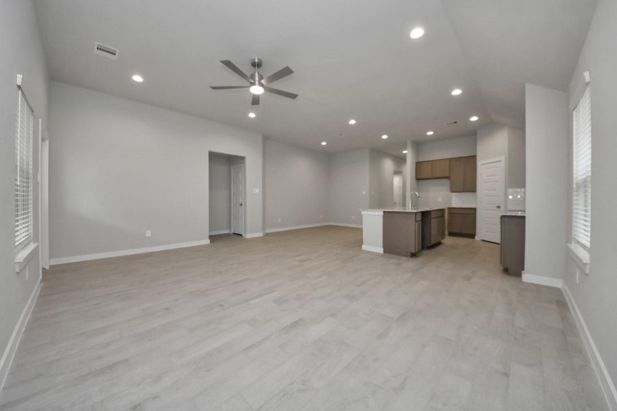 Welcome family and guests to your charming living room! With its high ceilings,recessed lighting, ceiling fan, custom paint, beautiful flooring, and large windows that letin abundant natural light, this room is perfect for gatherings. Sample photo of completed home with similar floor plan. Actual colors and selections may vary. Welcome family and guests to your charming living room! With its high ceilings,recessed lighting, ceiling fan, custom paint, beautiful flooring, and large windows that letin abundant natural light, this room is perfect for gatherings. Sample photo of completed home with similar floor plan. Actual colors and selections may vary.
