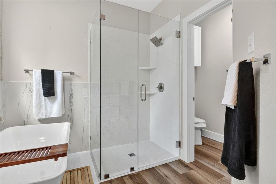 Custom tile and shower doors for master/ primary bath and custom tile on walls behind the Hollywood bath soaking tube.