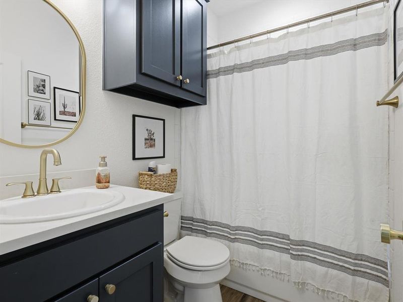 Full bath featuring vanity and toilet