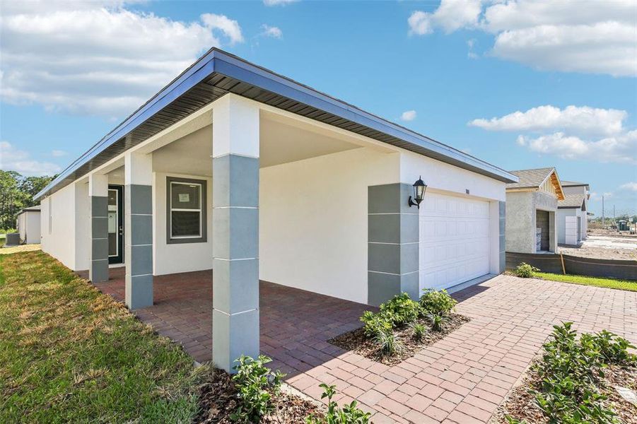 Front exterior of a new home in Villamar - Classic Series, Winter Haven, FL, highlighting curb appeal (Image 20). Front exterior of a new home in Villamar - Classic Series, Winter Haven, FL, highlighting curb appeal (Image 20).