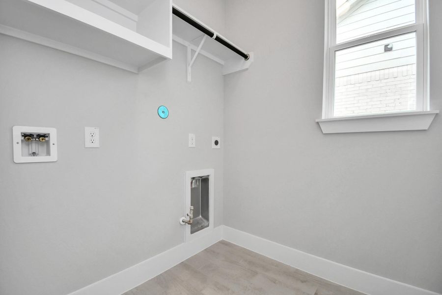 A perfect blend of functionality and comfort. Capture the essence of easy living with a first-floor laundry room, thoughtfully equipped with shelving for effortless organization. Both electric and gas connections available. A perfect blend of functionality and comfort. Capture the essence of easy living with a first-floor laundry room, thoughtfully equipped with shelving for effortless organization. Both electric and gas connections available.