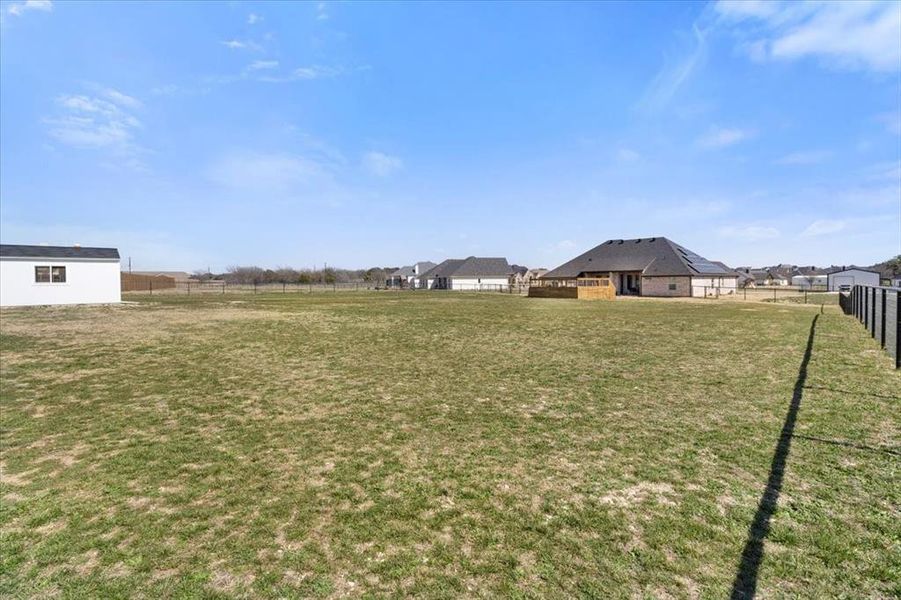 View of yard featuring a residential view and fence