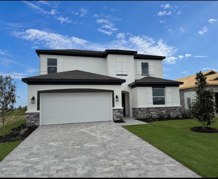 Front exterior of a new home in Coasterra, Palmetto, FL, highlighting curb appeal (Image 1). Front exterior of a new home in Coasterra, Palmetto, FL, highlighting curb appeal (Image 1).