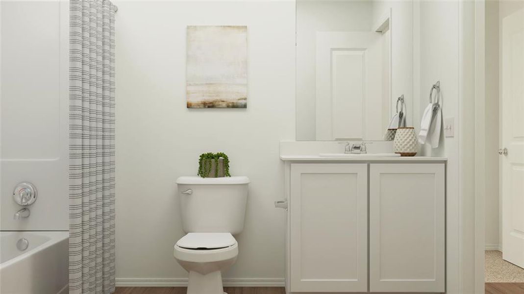 Full bathroom featuring vanity, shower / bath combo with shower curtain, and toilet