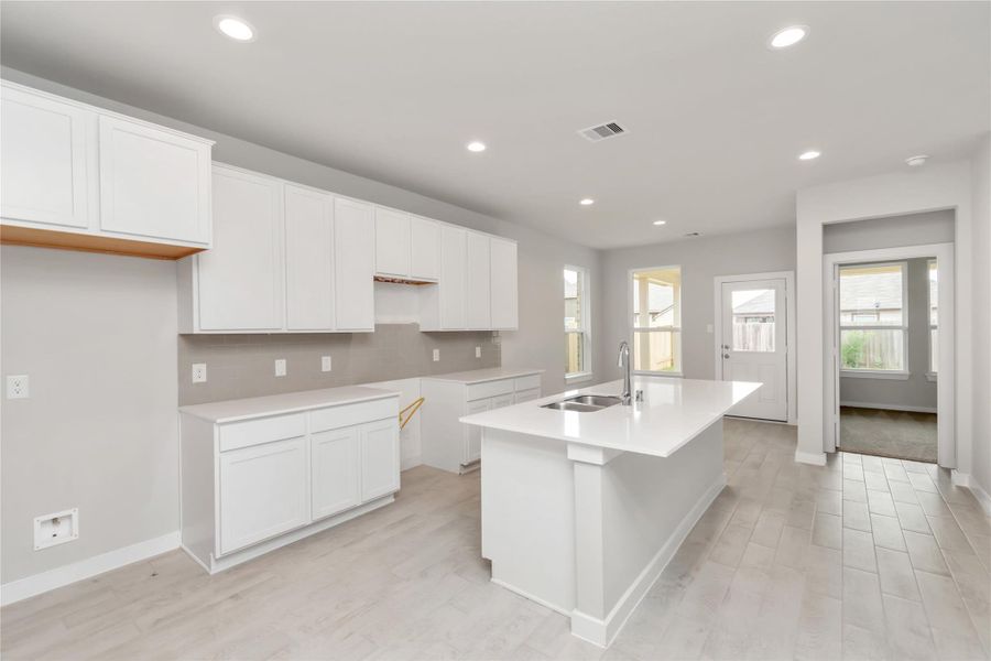 Discover another perspective of this stunning kitchen, generously appointed with an abundance of counter space. Sample photo of completed home with similar floor plan. As-built interior colors and selections may vary Discover another perspective of this stunning kitchen, generously appointed with an abundance of counter space. Sample photo of completed home with similar floor plan. As-built interior colors and selections may vary