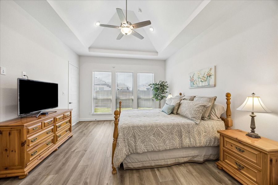 Stunning primary bedroom with soaring ceilings and ample space