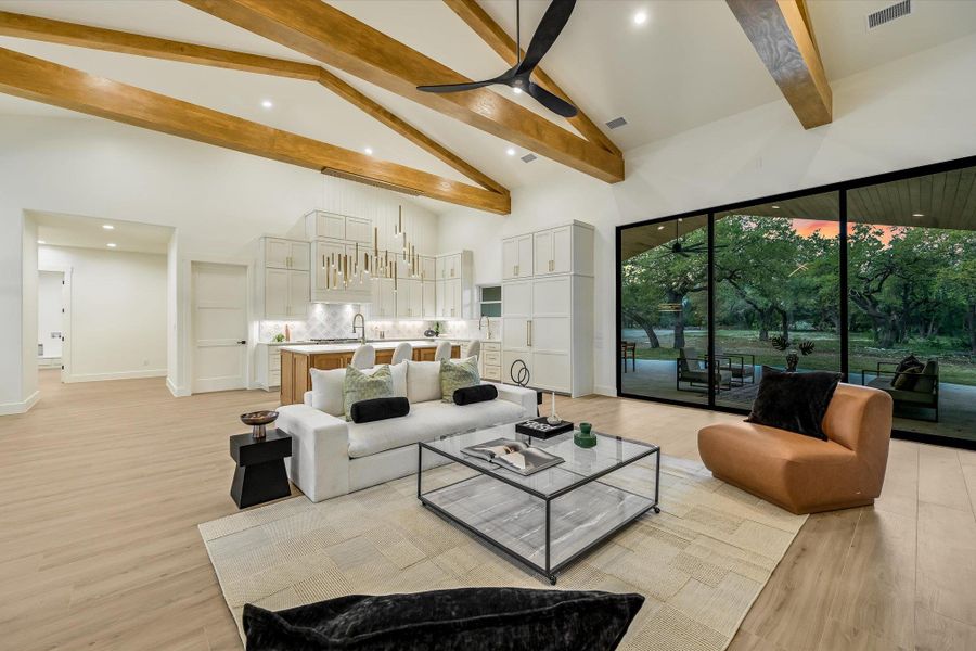 Living room featuring ceiling fan, light wood-style floors, lofted ceiling, and recessed lighting