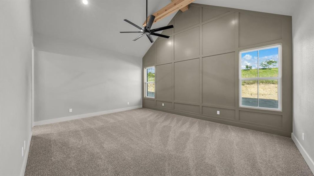 Vaulted ceiling featuring exposed wood beams and a contemporary ceiling fan Vaulted ceiling featuring exposed wood beams and a contemporary ceiling fan