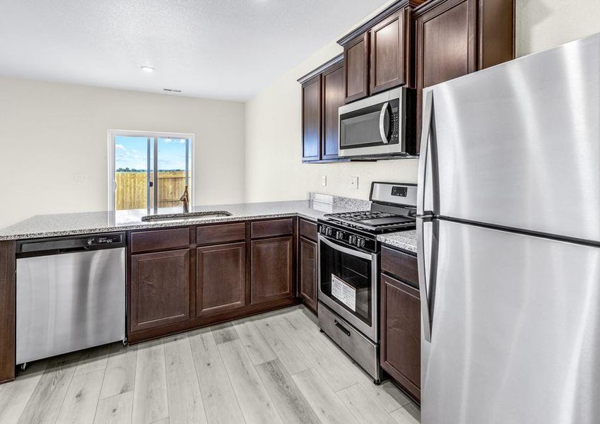 Upgraded kitchen with espresso cabinets, granite countertops, and an undermount sink.