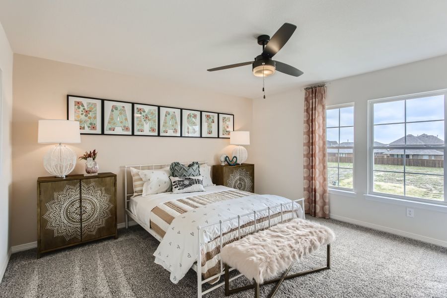 A bedroom with a bed and a fan.