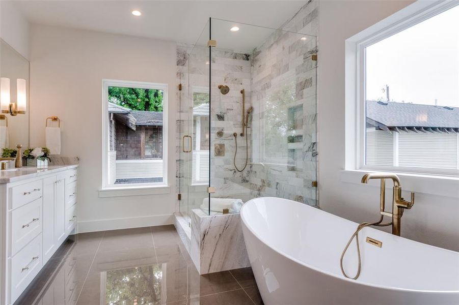 Bathroom with vanity, recessed lighting, a stall shower, tile patterned floors, and a soaking tub Bathroom with vanity, recessed lighting, a stall shower, tile patterned floors, and a soaking tub