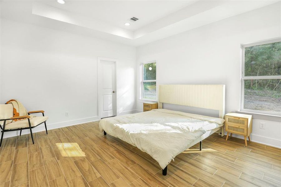 The primary bedroom is extremely large, providing a private retreat from the other two rooms. Bed shown is a king size and there is plenty of room left.