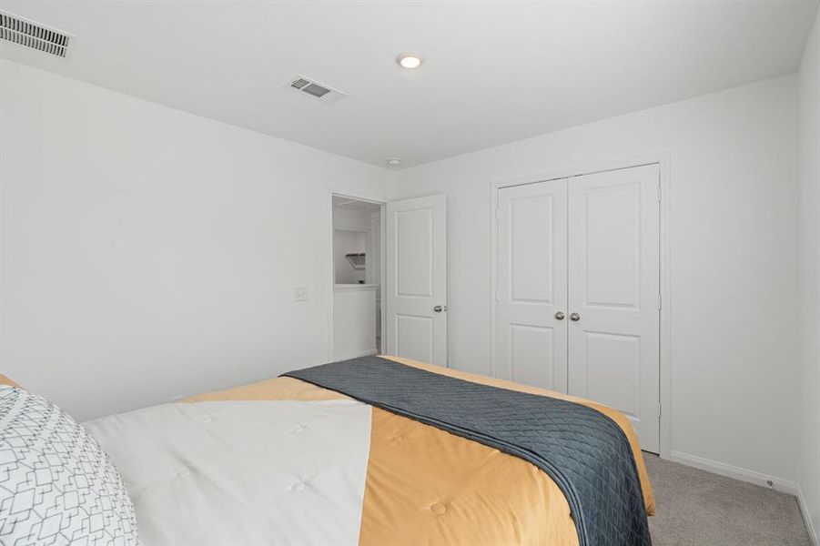 An additional view of the Stunning Secondary bedroom which features plush carpet, oversized window and neutral finishes.