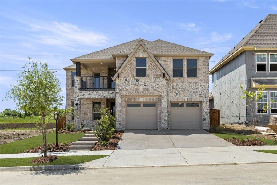 Front exterior of a new home in Inspiration, Seis Lagos, TX, highlighting curb appeal (Image 26). Front exterior of a new home in Inspiration, Seis Lagos, TX, highlighting curb appeal (Image 26).