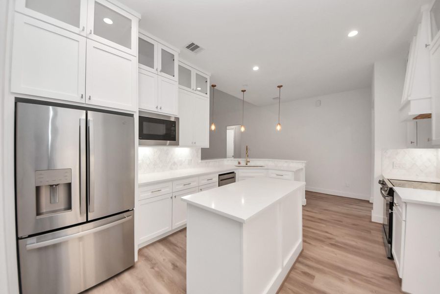 Gourmet kitchen featuring stainless steel appliances and ample counter space.