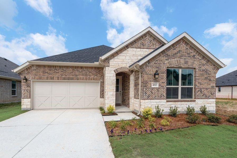 Front exterior of a new home in Spiritas Ranch, Little Elm, TX, highlighting curb appeal (Image 22).
